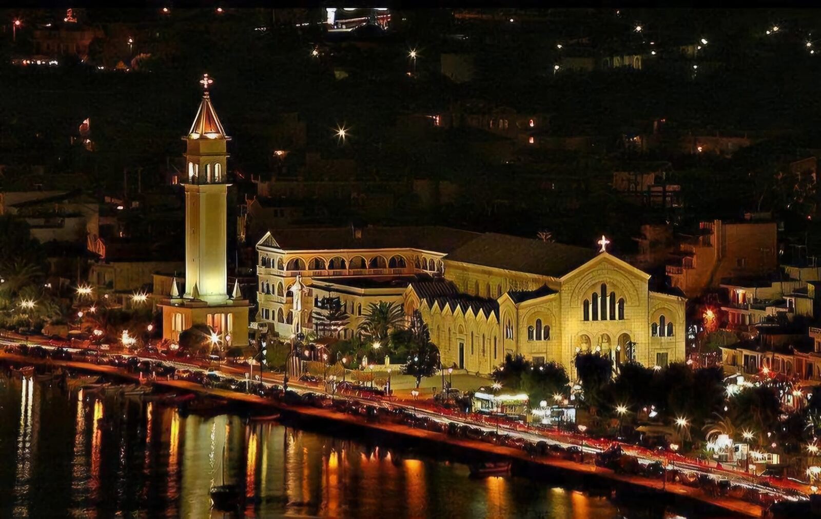 The Church of Saint Dionysios illuminated at night above Zakynthos Town harbour